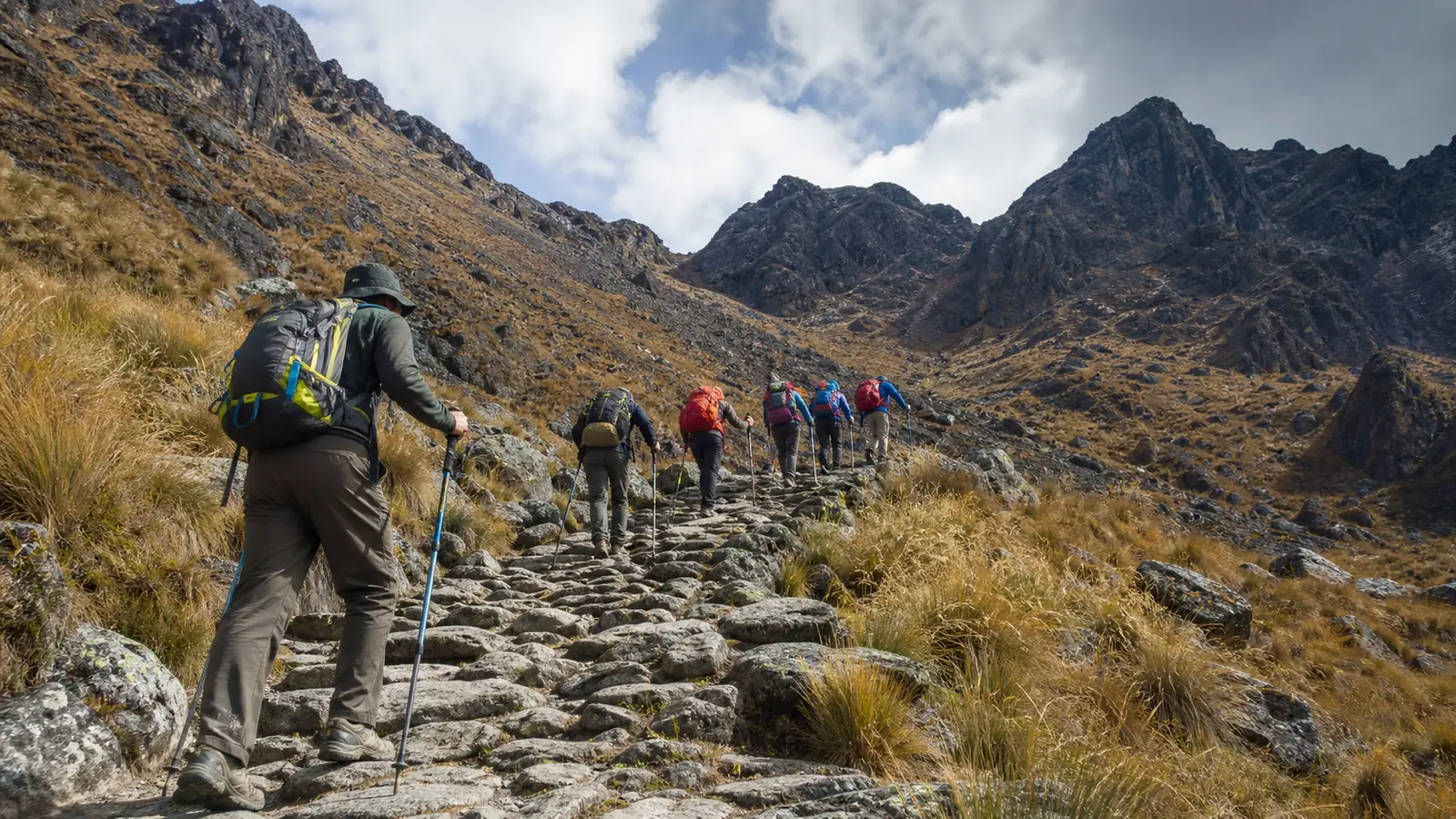 Hikers climbing the steep high-altitude approach to Dead Woman's Pass